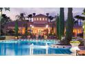 Resort-style pool with clubhouse and lush landscaping at night at 8763 Worldquest Blvd # 5503, Orlando, FL 32821