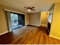 Spacious living room featuring wood-look floors and access to a private balcony at 180 Waterfall Way # 203, Altamonte Springs, FL 32714
