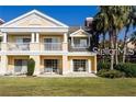 Inviting exterior of a two-story townhome with a landscaped lawn at 1304 Seven Eagles Ct # 1304, Reunion, FL 34747