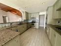 Modern kitchen with granite countertops and stainless steel appliances at 368 Fairgreen Pl, Casselberry, FL 32707