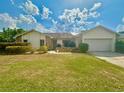 Single-story home with attached garage and landscaped yard at 368 Fairgreen Pl, Casselberry, FL 32707