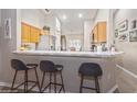 Kitchen features a breakfast bar with three stools and wood cabinets at 218 Hillcrest Dr, Davenport, FL 33897