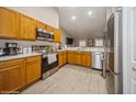 Modern kitchen with stainless steel appliances and wood cabinets at 218 Hillcrest Dr, Davenport, FL 33897