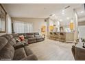 Open living room with a comfortable sectional sofa and a breakfast bar at 218 Hillcrest Dr, Davenport, FL 33897