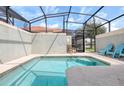 Private screened-in pool with patio furniture at 8951 Bismarck Palm Rd, Kissimmee, FL 34747