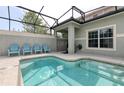Private screened-in pool with patio furniture and grill at 8951 Bismarck Palm Rd, Kissimmee, FL 34747
