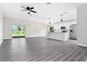 Open concept kitchen with island and stainless steel appliances at 43 S Kentucky Ave, Umatilla, FL 32784