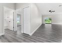 Bright hallway with grey flooring and access to bedrooms and bath at 43 S Kentucky Ave, Umatilla, FL 32784