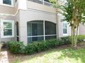 Private screened porch with lush landscaping at 3480 Soho St # 101, Orlando, FL 32835