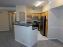 Modern kitchen with stainless steel appliances and a breakfast bar at 3480 Soho St # 101, Orlando, FL 32835