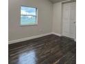 Spacious bedroom with dark wood floors at 1526 Lakewood Rd, Davenport, FL 33837