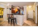 Kitchen with breakfast bar and view into entryway at 912 Charo Pkwy # 214, Davenport, FL 33897