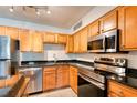 Modern kitchen with stainless steel appliances and wood cabinets at 320 Black Oak Ct # 107, Altamonte Springs, FL 32701