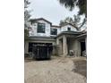 Two-story house under construction, showcasing a modern design and large windows at 3304 Harrison Ave, Orlando, FL 32804