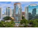 Aerial view of a high-rise building in a city setting with surrounding buildings and lush green spaces at 322 E Central Blvd # 710, Orlando, FL 32801