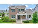 Two-story craftsman style home with front porch and landscaping at 7540 Estuary Lake Loop, Celebration, FL 34747
