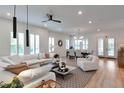 Open concept living space with large windows and light, neutral decor at 7540 Estuary Lake Loop, Celebration, FL 34747