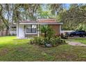 Single-story home with stone facade, landscaping, and a palm tree at 424 E Welch Rd, Apopka, FL 32712