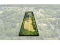 Aerial view of a long rectangular lot surrounded by lush green trees and houses at 424 E Welch Rd, Apopka, FL 32712