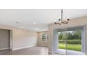 Bright dining room with sliding glass doors to backyard at 3137 Legends Preserve Dr, Daytona Beach, FL 32124