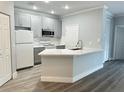 Modern kitchen featuring gray cabinets and quartz countertops at 3561 Conroy Rd # 227, Orlando, FL 32839