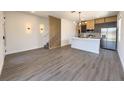 Open concept living area with modern kitchen, island, and staircase at 3229 Energy Dr, Kissimmee, FL 34747
