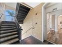 Modern stairwell with metal railings leading to condo unit at 8100 Princess Palm Ln # 201, Kissimmee, FL 34747