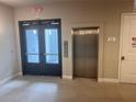 Building hallway with elevator and exit doors at 7740 Sandy Ridge Dr # 213, Reunion, FL 34747