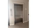 Modern stainless steel elevator in a well-lit building at 7740 Sandy Ridge Dr # 213, Reunion, FL 34747