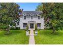 Two story house with white brick exterior, manicured lawn, and walkway at 2234 Via Luna, Winter Park, FL 32789