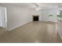 Living room with tile flooring, a fireplace and access to a patio at 5545 Devonbriar Way # I101, Orlando, FL 32822
