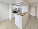 Kitchen features white cabinets, granite countertops and stainless steel appliances at 5545 Devonbriar Way # I101, Orlando, FL 32822