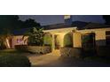 Night view of house entrance with landscaping at 342 Maple Dr, Longwood, FL 32750