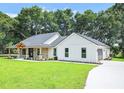 Two-story home with white siding and a stone facade at 19906 Eldorado Dr, Eustis, FL 32736