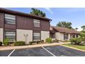 Front view of condo building showcasing parking and landscaping at 225 Terrace Hill Blvd # 1C, Debary, FL 32713