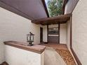 Condo entrance with tiled flooring and exterior light fixture at 225 Terrace Hill Blvd # 1C, Debary, FL 32713