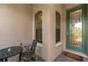 Inviting front entryway with a green door and a small sitting area at 1282 Zeek Ridge St, Clermont, FL 34715