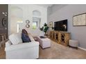 Spacious living room with sectional sofa and large TV at 4036 Oakrise Loop, Davenport, FL 33837