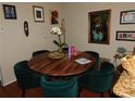 Round wooden dining table with six green velvet chairs at 208 Afton Sq # 307, Altamonte Springs, FL 32714