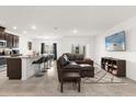 Open concept living room and kitchen with breakfast bar at 3387 Beaute Dr, Kissimmee, FL 34746