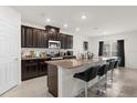Modern kitchen with granite countertops and dark wood cabinets at 3387 Beaute Dr, Kissimmee, FL 34746