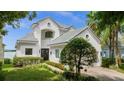 Two story house with white exterior, grey tile roof and landscaping at 8629 Saint Marino Blvd, Orlando, FL 32836