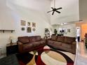 Spacious living room with high ceilings and two brown couches at 122 Crown Point Cir, Longwood, FL 32779