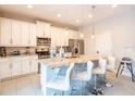 Modern kitchen with white cabinets and granite island at 171 Burma St, Kissimmee, FL 34747