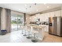 Modern kitchen with white cabinets and granite island at 171 Burma St, Kissimmee, FL 34747