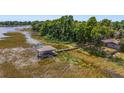 Aerial view of a lakefront property with a dock at 1149 Shady Cove E Rd, Haines City, FL 33844