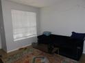 Living room with a comfy couch and large window at 824 Grand Regency Pt # 102, Altamonte Springs, FL 32714