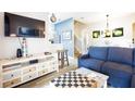 Living room features a sectional sofa and a chessboard coffee table at 244 Capri Dr, Davenport, FL 33897