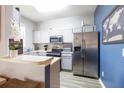 Modern kitchen with stainless steel appliances and white cabinets at 244 Capri Dr, Davenport, FL 33897