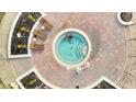 Relaxing hot tub surrounded by a brick patio and landscaping at 8801 Worldquest Blvd # 4406, Orlando, FL 32821